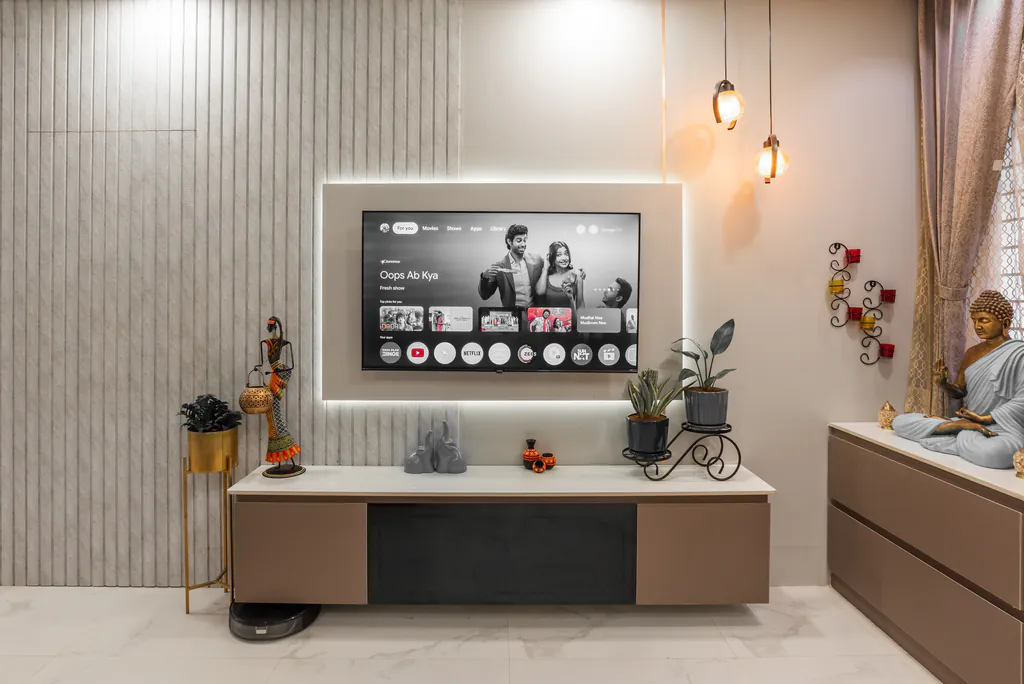 Living room TV wall with fluted panels, a wall-mounted TV and amber pendant lights